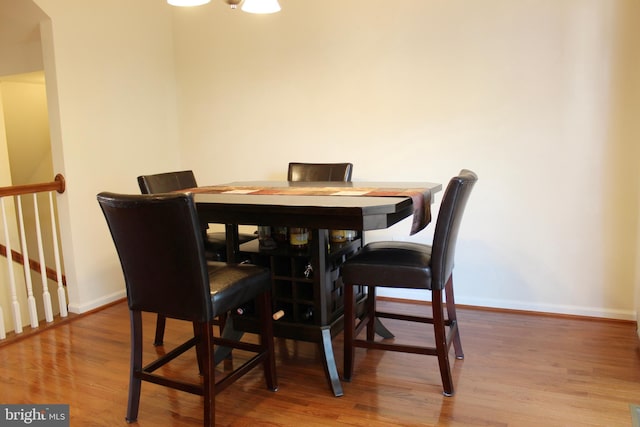 dining room featuring baseboards and wood finished floors