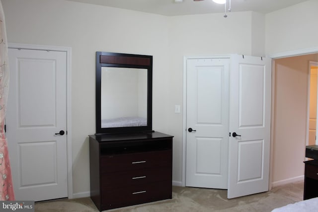 bedroom featuring light colored carpet and baseboards