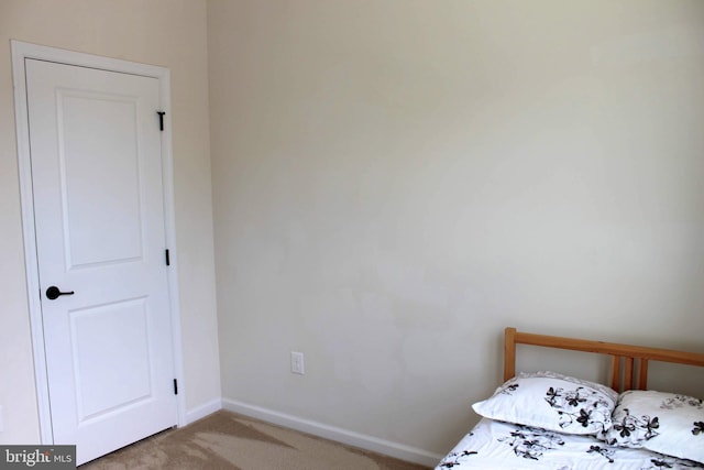 unfurnished bedroom featuring baseboards and carpet