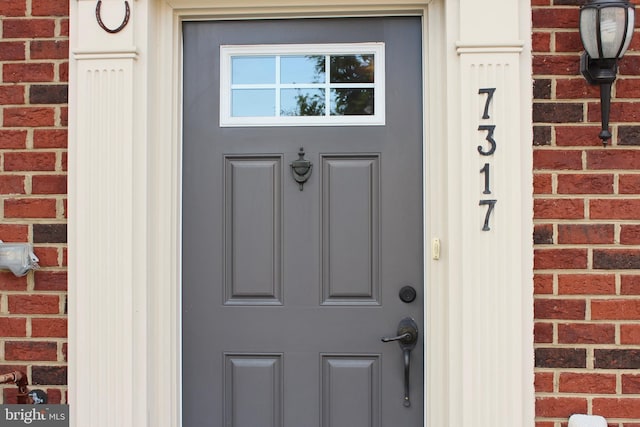 entrance to property with brick siding