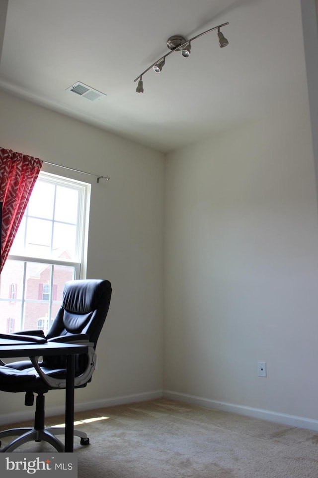 office space featuring visible vents, baseboards, track lighting, and carpet flooring