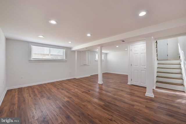 basement featuring dark wood finished floors, recessed lighting, stairs, and baseboards