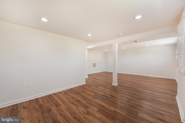 finished basement featuring visible vents, recessed lighting, baseboards, and dark wood-style flooring