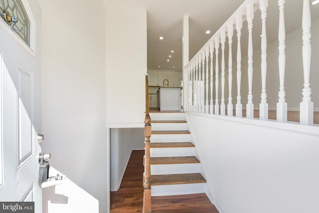 staircase featuring recessed lighting and wood finished floors