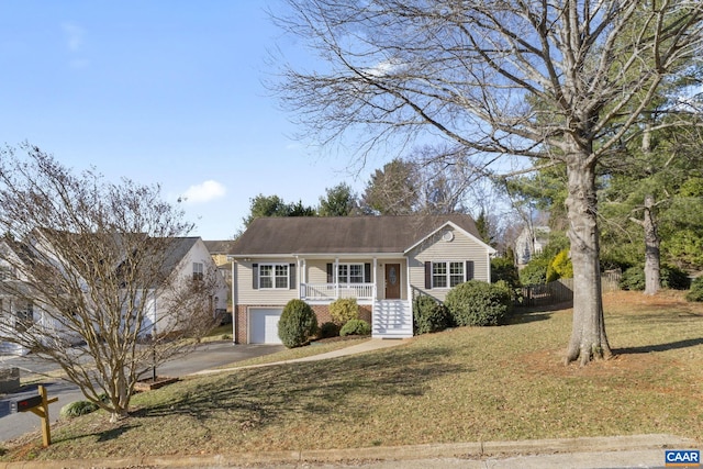 view of front facade with brick siding, an attached garage, a front lawn, covered porch, and driveway