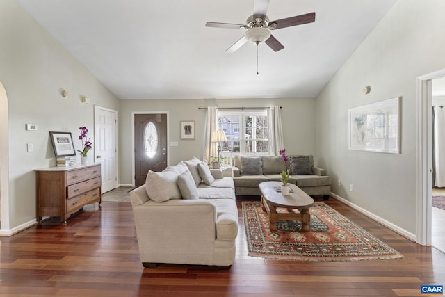 living room with dark wood-style floors, ceiling fan, baseboards, and lofted ceiling