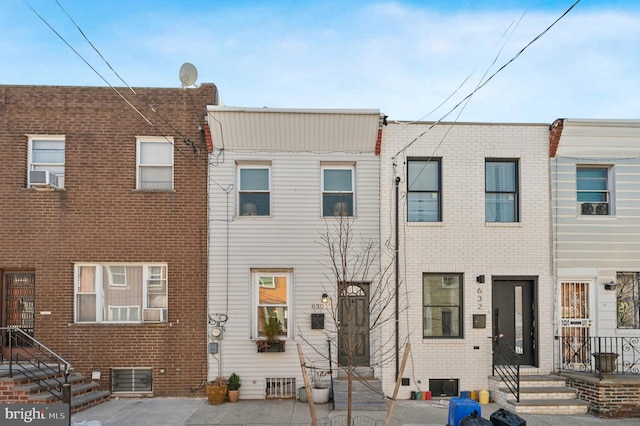 view of front of house with cooling unit, brick siding, and entry steps