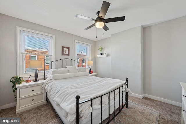 carpeted bedroom with a ceiling fan and baseboards