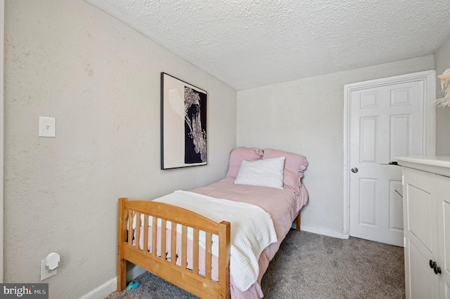 carpeted bedroom featuring baseboards, a textured ceiling, and a textured wall