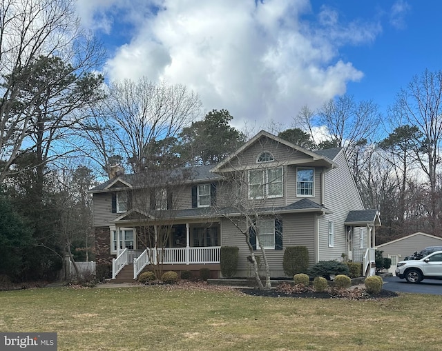 view of front of house with a garage, a chimney, a porch, and a front yard