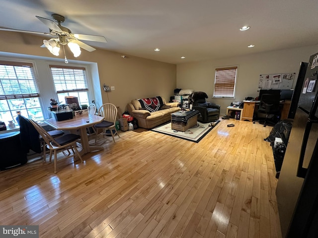 living area with recessed lighting, light wood-style flooring, and a ceiling fan