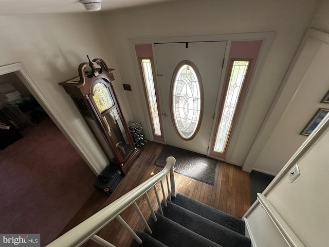 foyer featuring stairway and wood finished floors