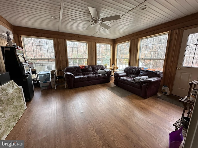 living room featuring wood ceiling, wood finished floors, and ceiling fan