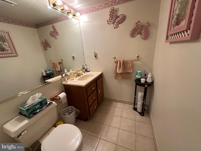 bathroom with vanity, visible vents, baseboards, tile patterned flooring, and toilet