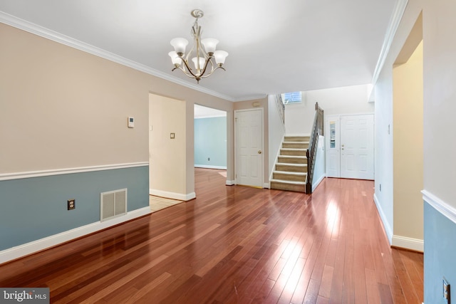 interior space featuring visible vents, baseboards, stairs, and hardwood / wood-style flooring