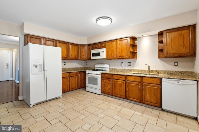 kitchen with a sink, open shelves, white appliances, and brown cabinets