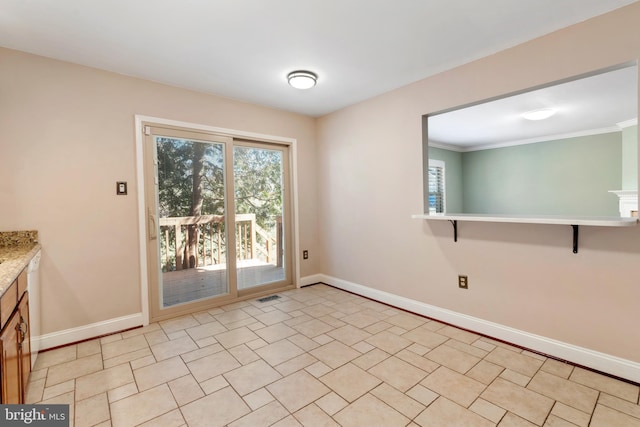 doorway to outside with visible vents, baseboards, and ornamental molding