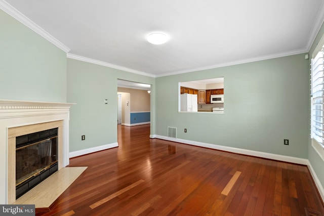 unfurnished living room featuring visible vents, a fireplace with flush hearth, wood finished floors, crown molding, and baseboards