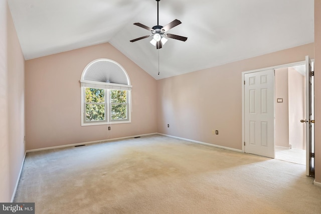 spare room featuring a ceiling fan, visible vents, baseboards, high vaulted ceiling, and light colored carpet