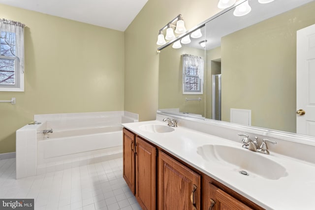 bathroom with a bath, tile patterned flooring, a stall shower, and a sink