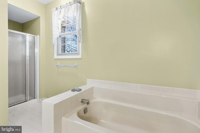 bathroom with tile patterned floors, a bath, and a stall shower