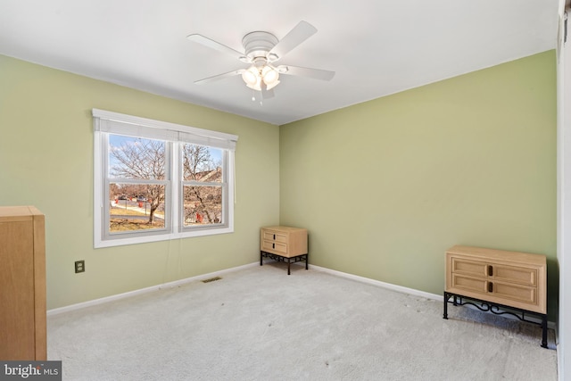 unfurnished room featuring visible vents, baseboards, carpet, and ceiling fan