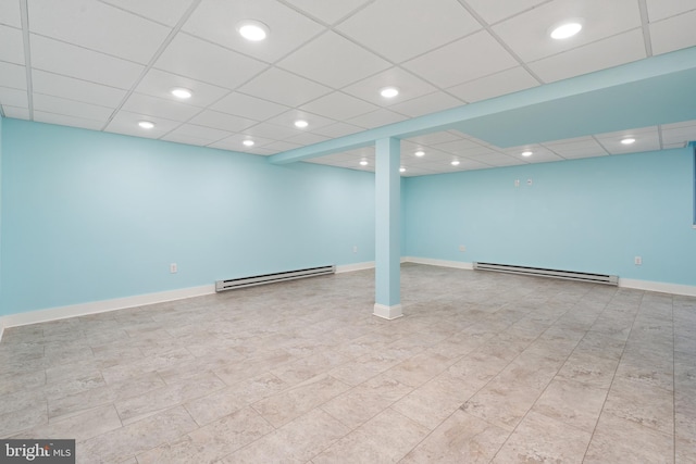 finished basement featuring recessed lighting, baseboards, and a baseboard radiator