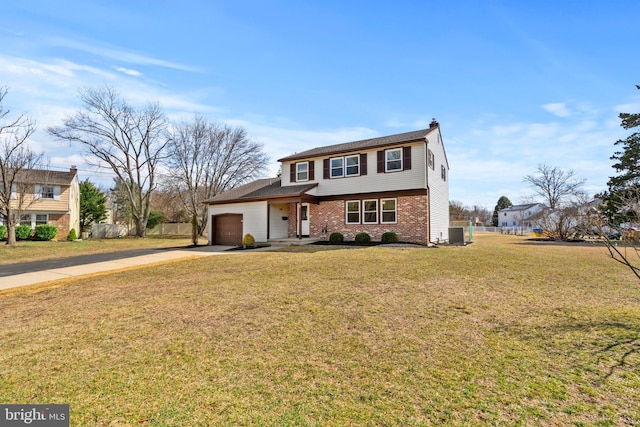 colonial-style house with brick siding, an attached garage, fence, a front yard, and driveway