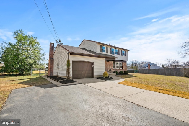 view of front of home featuring driveway, a front lawn, fence, an attached garage, and a chimney