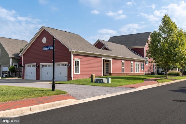 view of front of property with driveway, a front lawn, and a shingled roof