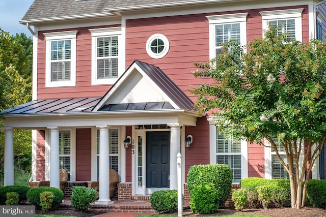 view of front of home featuring a standing seam roof, covered porch, and metal roof