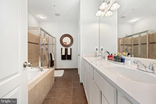 full bath with tile patterned floors, a bath, a shower stall, and a sink