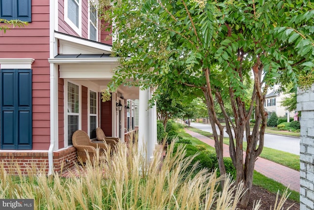 view of side of property with a porch