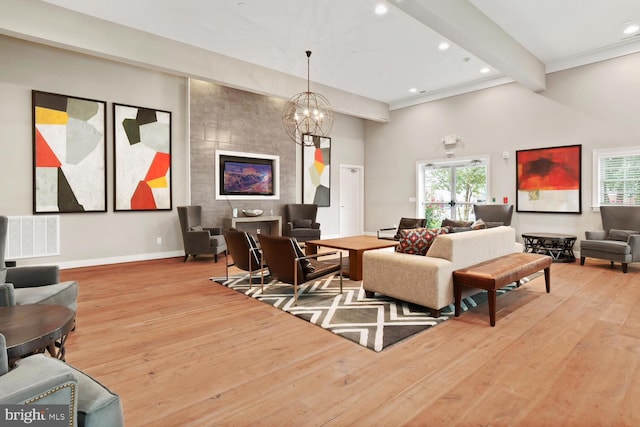 living room with hardwood / wood-style floors, beam ceiling, recessed lighting, and baseboards