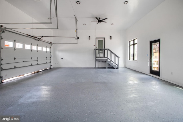 garage featuring a garage door opener and a ceiling fan