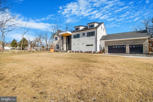 view of front of home with stucco siding, a front lawn, and a garage