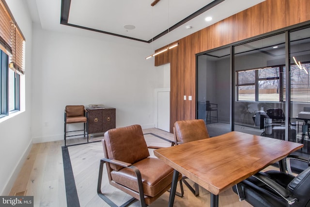 dining room with baseboards and light wood finished floors