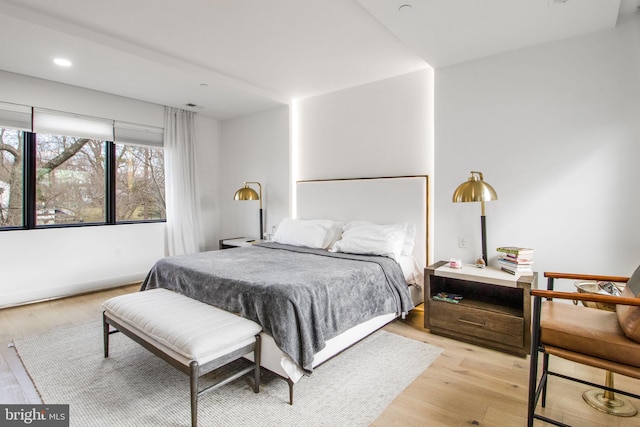 bedroom with recessed lighting, baseboards, and light wood finished floors