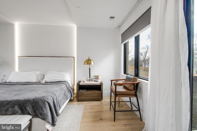 bedroom featuring visible vents and light wood-type flooring