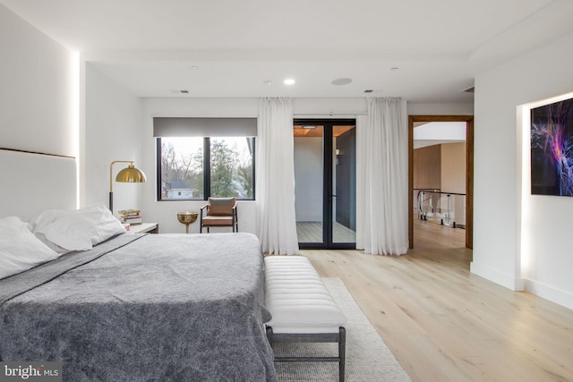 bedroom featuring wood finished floors, baseboards, visible vents, recessed lighting, and access to exterior