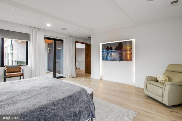 bedroom featuring wood finished floors, visible vents, baseboards, recessed lighting, and access to exterior