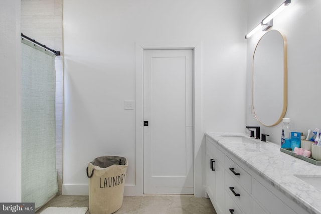 full bathroom with double vanity and a sink