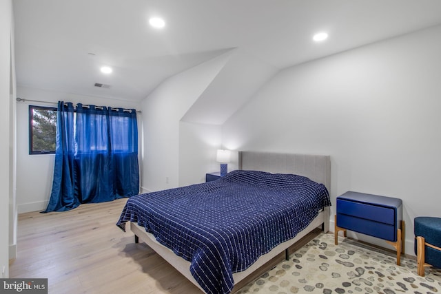 bedroom featuring recessed lighting, visible vents, lofted ceiling, and wood finished floors