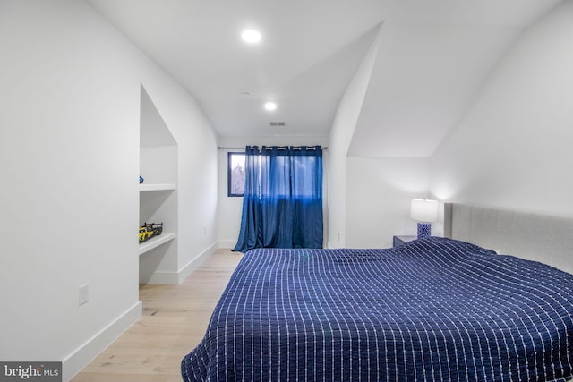 bedroom with recessed lighting, visible vents, baseboards, and wood finished floors