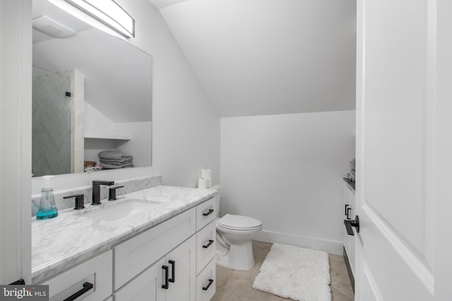 bathroom with vanity, baseboards, tiled shower, lofted ceiling, and toilet