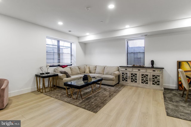 living area with recessed lighting, baseboards, and wood finished floors