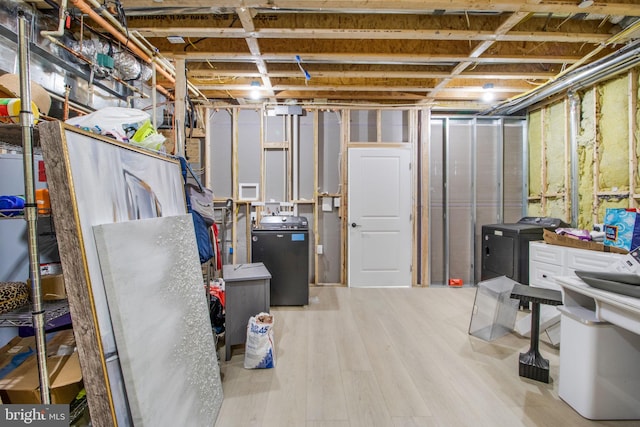 unfinished basement with wood finished floors and washing machine and dryer