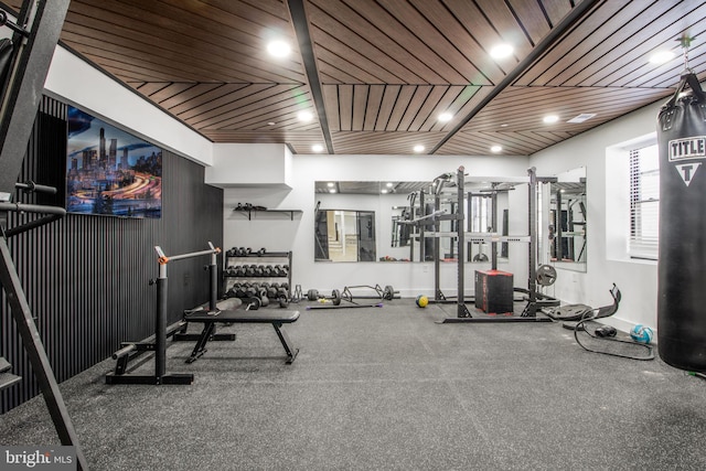 exercise area with recessed lighting, wood ceiling, and baseboards