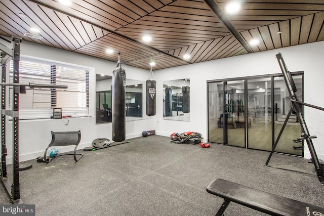 exercise area with wood ceiling and baseboards