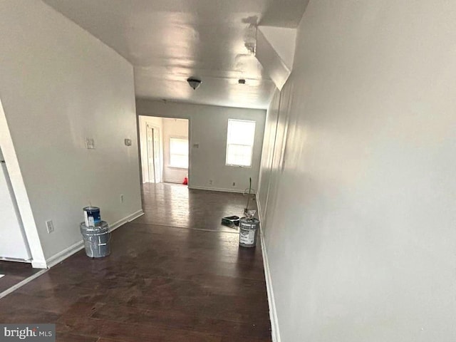 interior space featuring baseboards and wood finished floors